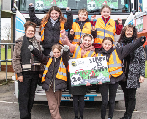 SIS-s-4 Members o the Road Safety Squad displaying the "Slower is Safer" campaign materials